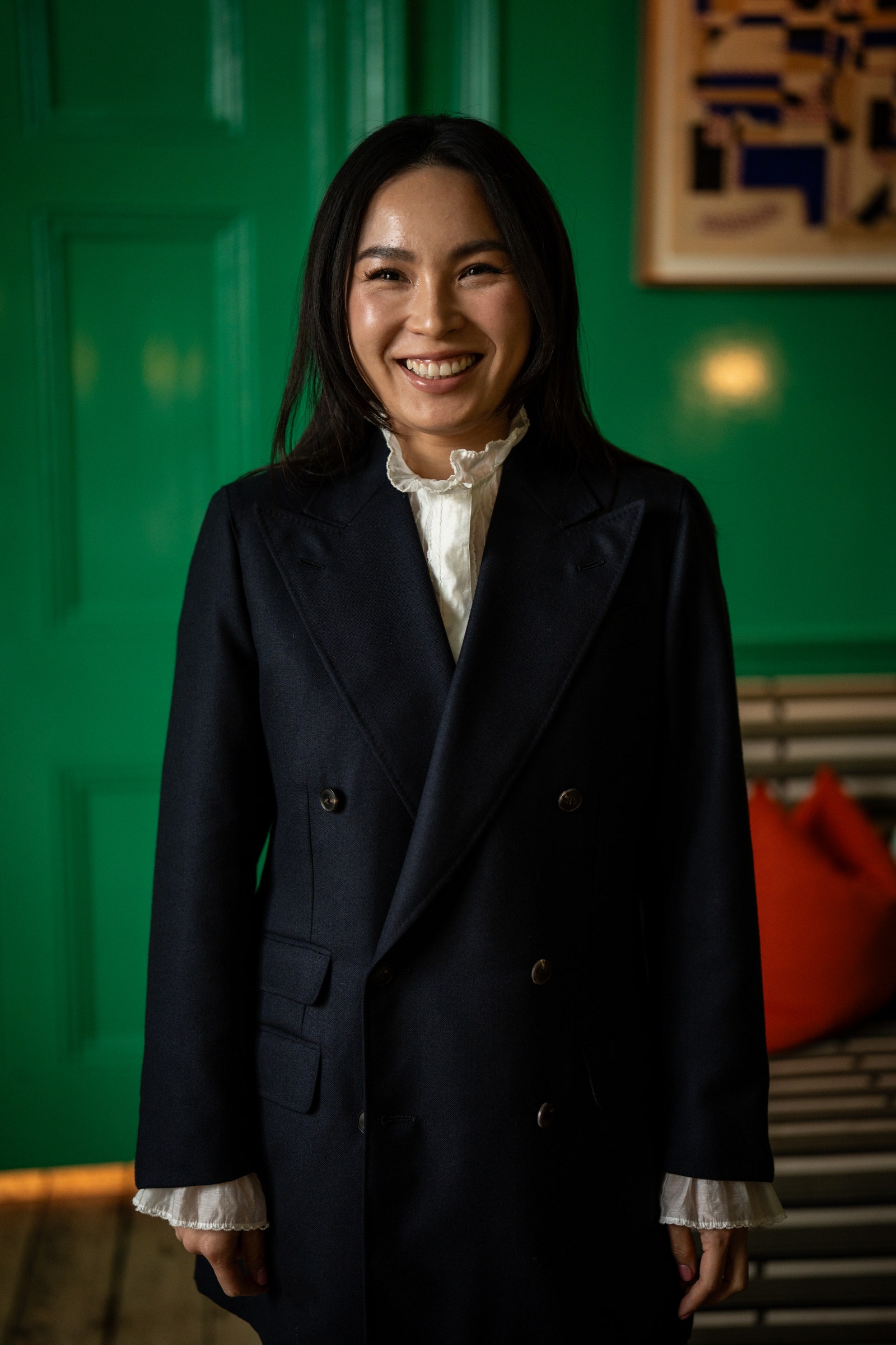 Image may contain Clothing Coat Blazer Jacket Face Happy Head Person Smile Adult and Dimples