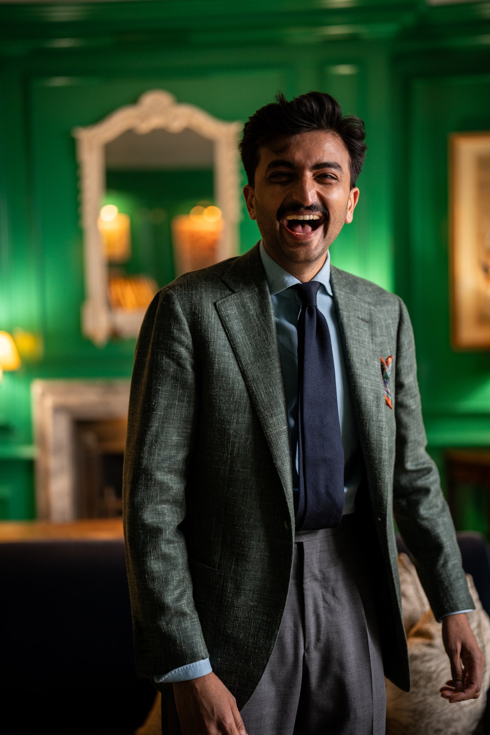 Image may contain Head Person Face Happy Laughing Smile Accessories Formal Wear Tie Blazer Clothing and Coat