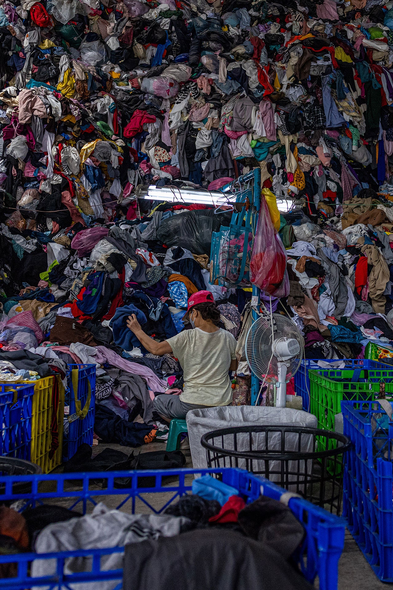 Textile waste. Image may contain Adult Person Accessories Bag Handbag Clothing Hat Laundry and Market